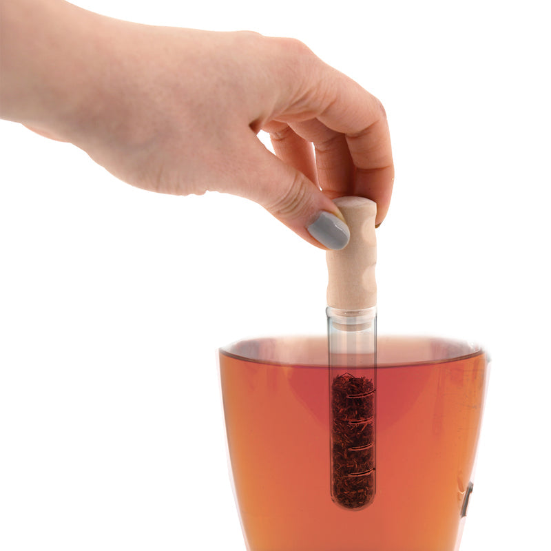 Someone holding the tea infuser stick in a cup of tea. 