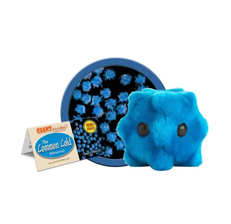 Image of the plush toy in front of an enlarged microscope image of the common cold virus. The product tag is also shown on the left. 