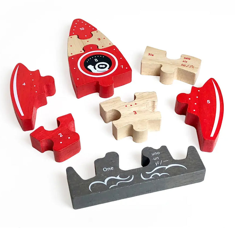 Wooden rocket ship puzzle for young children separated into seven parts.