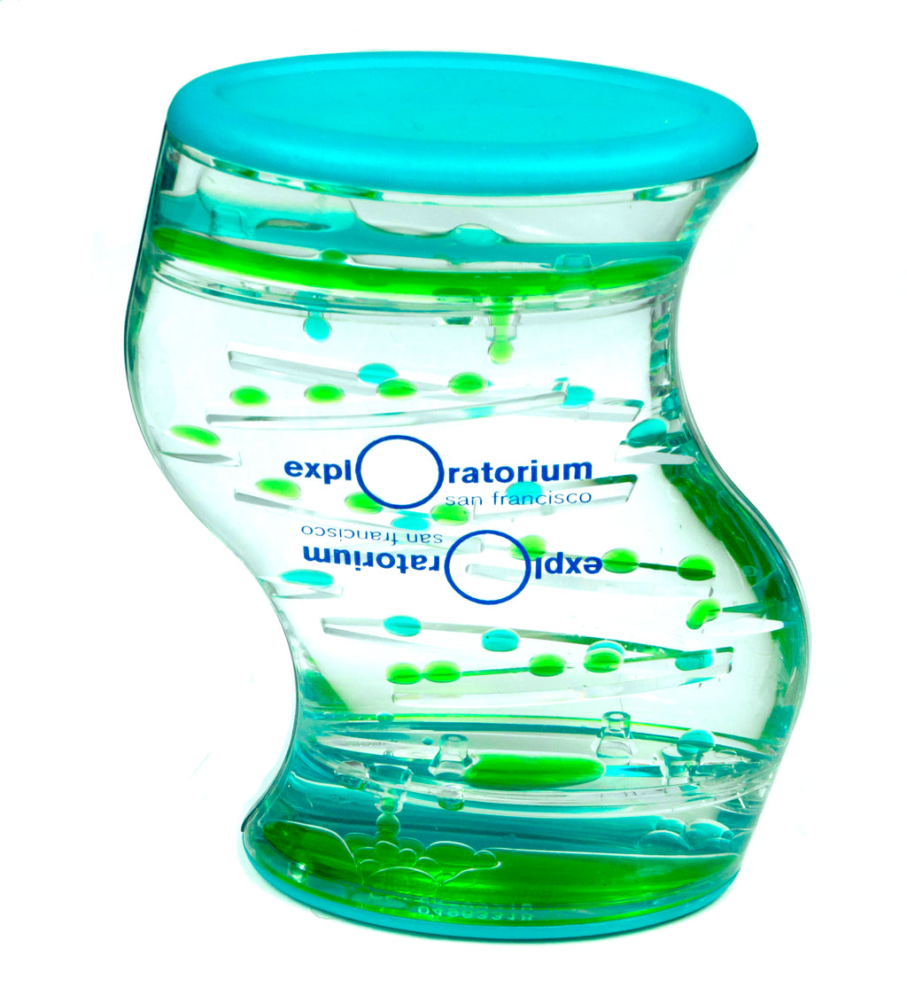 An s-shaped precise plastic flip-over liquid timer. The liquid is clear and green with teal accents and a blue Exploratorium logo.