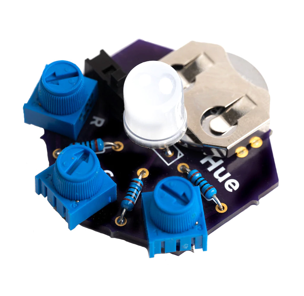A kit that changes through the hues of colors soldering kit put together; there is a black hexagon hue PCB attached with white RGB LED light, three light blue dials, and a silver coin holder.