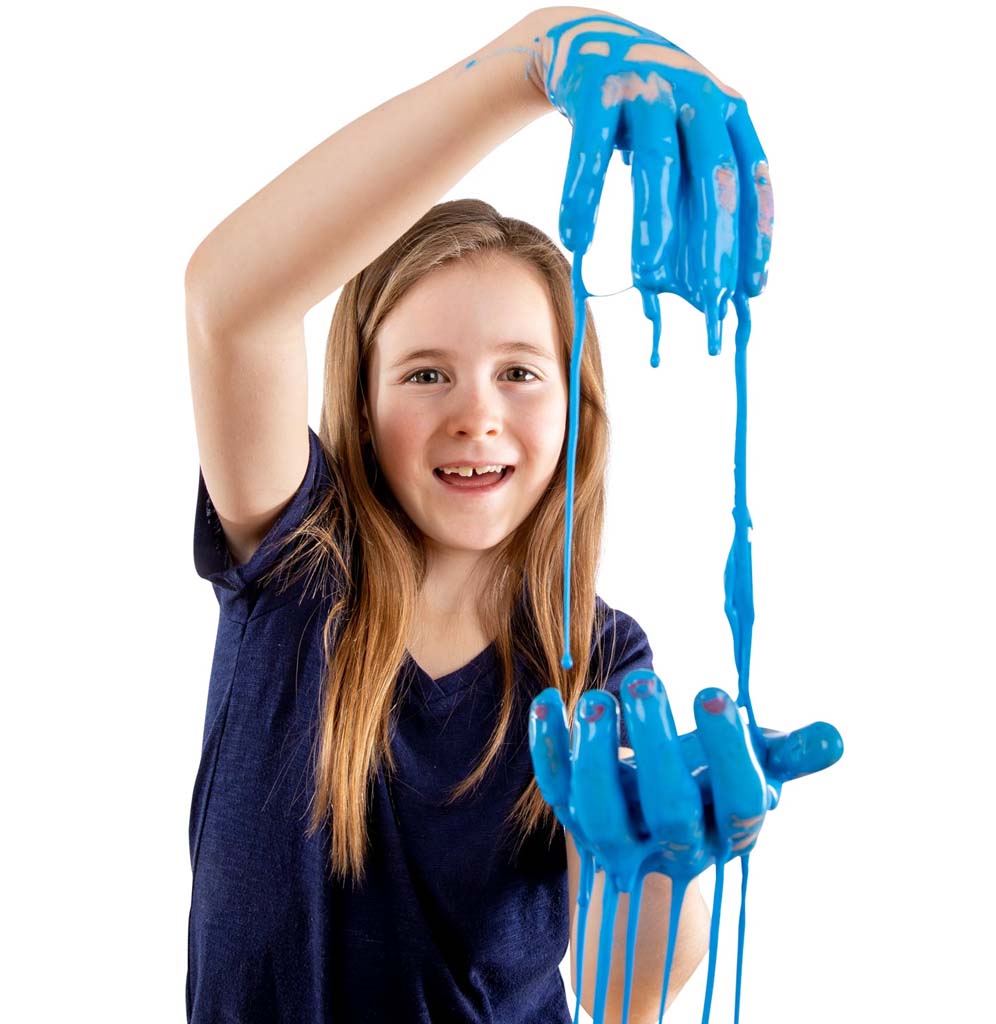 A young girl is dripping the blue-colored Oobleck from one hand to another.