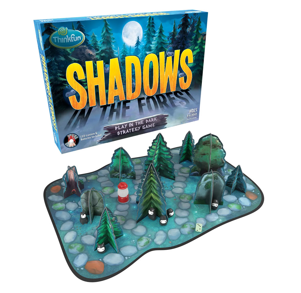 The game board is set up for gameplay. The gameboard is a green forest with pebbled walks and tiny lanterns. Shadows glow in yellow, and In The Forest is reflected in shadow. The game box is a forest scene with a large full moon.