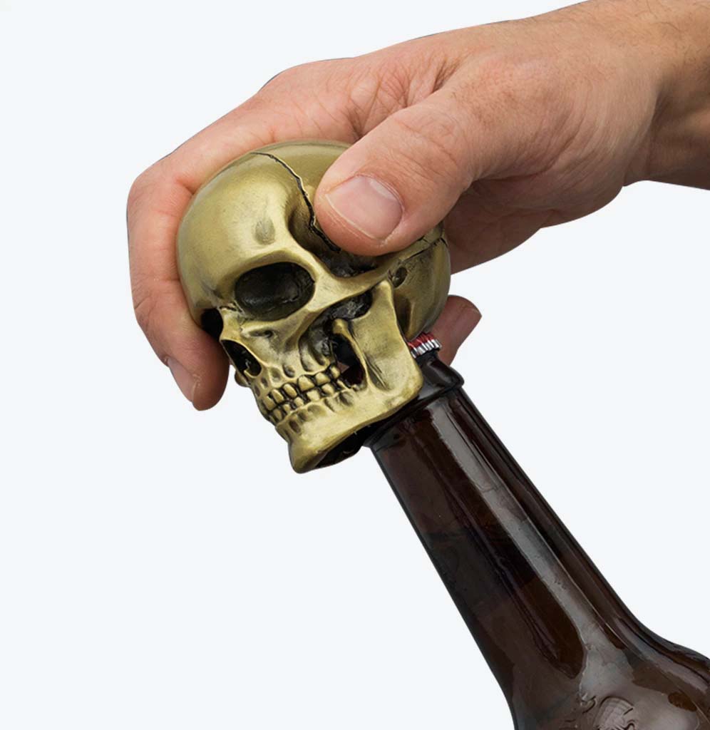 The skull bottle opener is on top of an amber bottle encasing the top. 