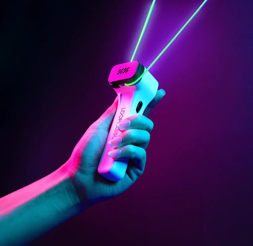 A hand is holding a plastic device that has neon green string connected to it. 