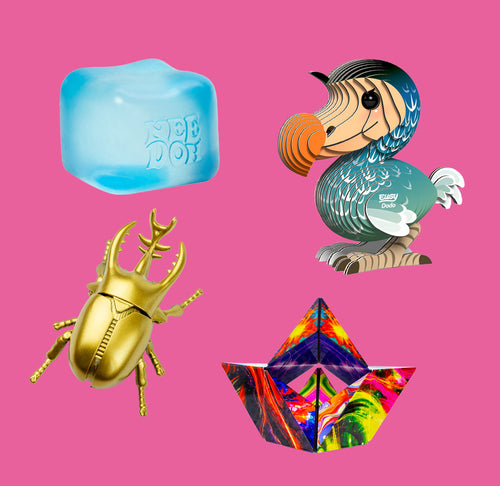 A blue cube, beetle, dodo, and geometric toy on a pink background