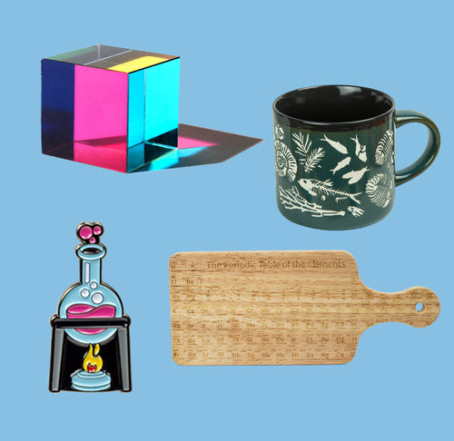 A colorful cube, cutting board, mug, and beaker pin are on a blue background