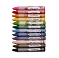 A vertical stack of twelve crayons in assorted colors, each with a white label showing the crayon's name and color description, on a plain white background.