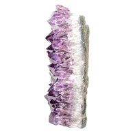 Amethyst crystal cluster side view on a white background