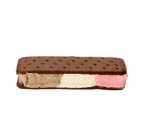 A rectangular chocolate ice cream sandwich with a perforated cookie top and layers of vanilla, chocolate, and pink strawberry ice cream.