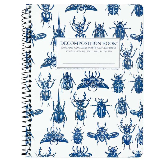 Spiral notebook with blue beetles against a white background