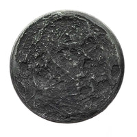 A round black iron coin with a highly detailed, textured lunar surface design featuring craters and shadows, isolated on a white background.