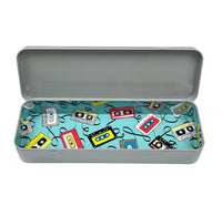 A rectangular metal pencil case with the lid open, featuring a retro cassette tape pattern on the interior lining.
