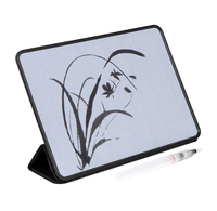 Black-framed digital drawing tablet displaying a delicate ink-style bamboo and flower sketch, with a white stylus beside it; calm minimalist scene.