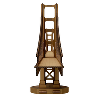 A brown, intricately detailed model of the Golden Gate Bridge is viewed straight-on, its towers and cables framing the roadway in a symmetrical, architectural display.