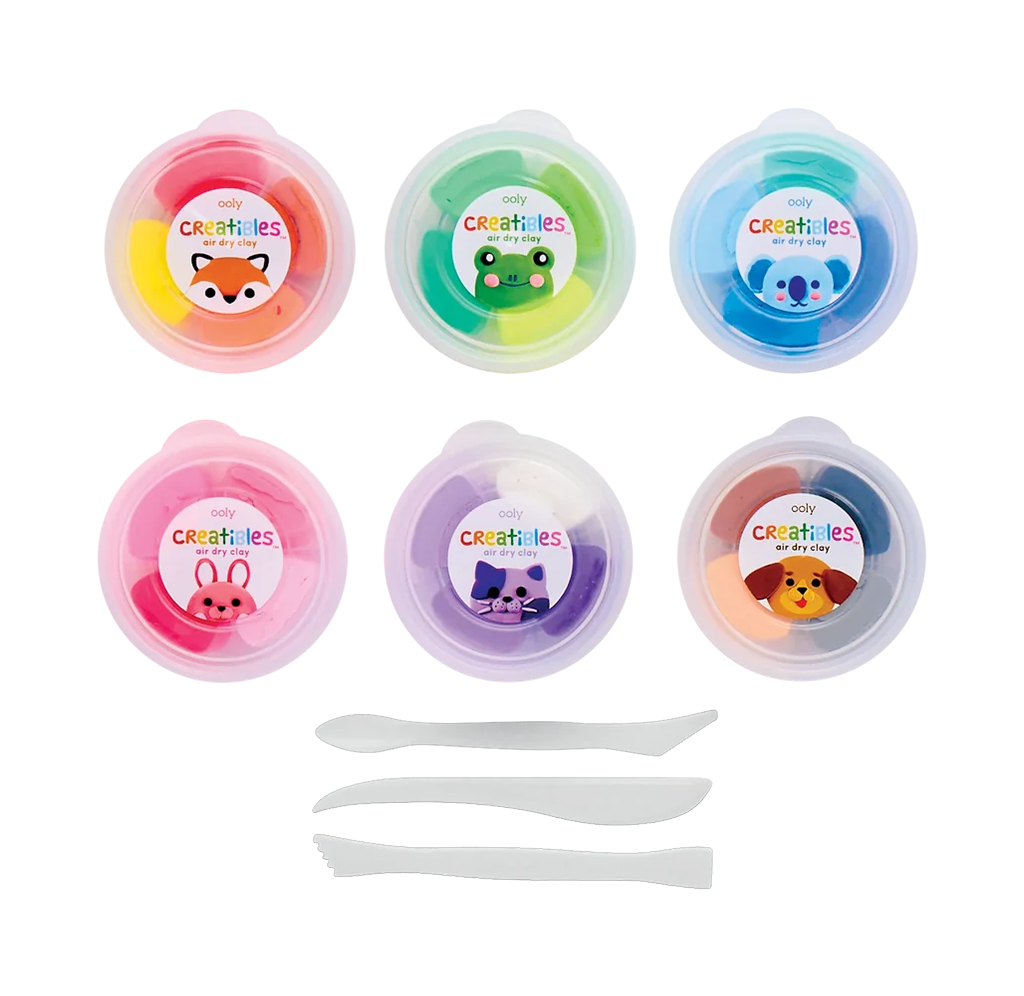 Six colorful Crayola-creature modeling dough tubs with fox, frog, koala, pig, cat, and lion labels, plus three white sculpting tools; playful craft set on a white background.