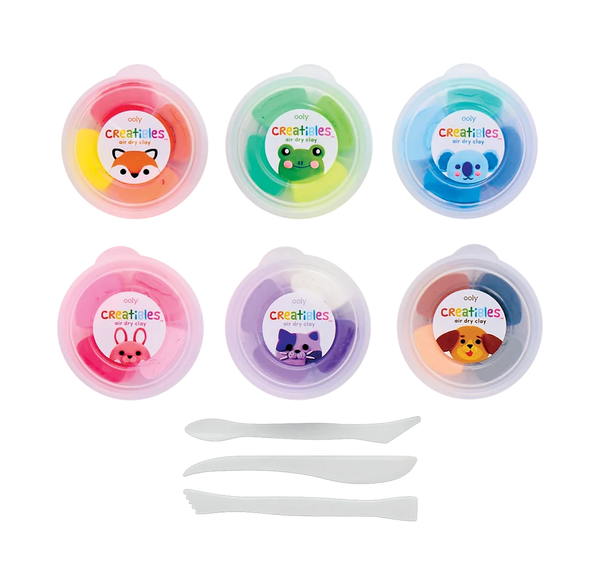 Six colorful Crayola-creature modeling dough tubs with fox, frog, koala, pig, cat, and lion labels, plus three white sculpting tools; playful craft set on a white background.