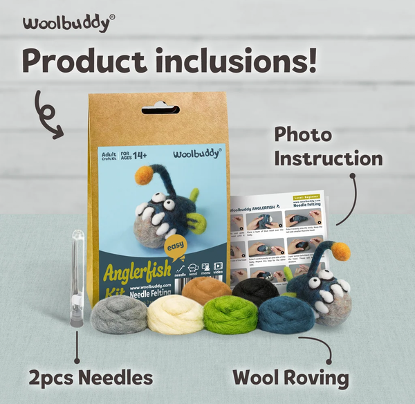 Woolbuddy Anglerfish needle-felting kit display shows the boxed kit, photo instruction sheet, two needles, and colorful wool roving on a pale surface; playful, inviting tone.