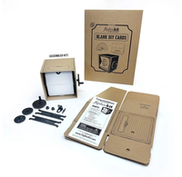 A DIY flipbook kit is arranged on a white background: kraft-cardboard packaging, blank cards, instruction sheet, assembled viewer, and loose parts, with a playful maker tone.