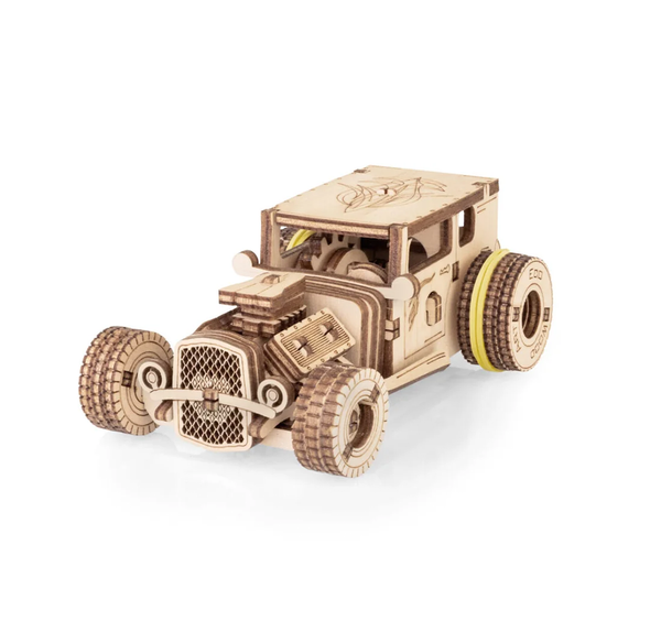 A tan wooden 3D puzzle model of a vintage hot rod, with detailed grille, exposed engine, and chunky wheels, shown against a white background.