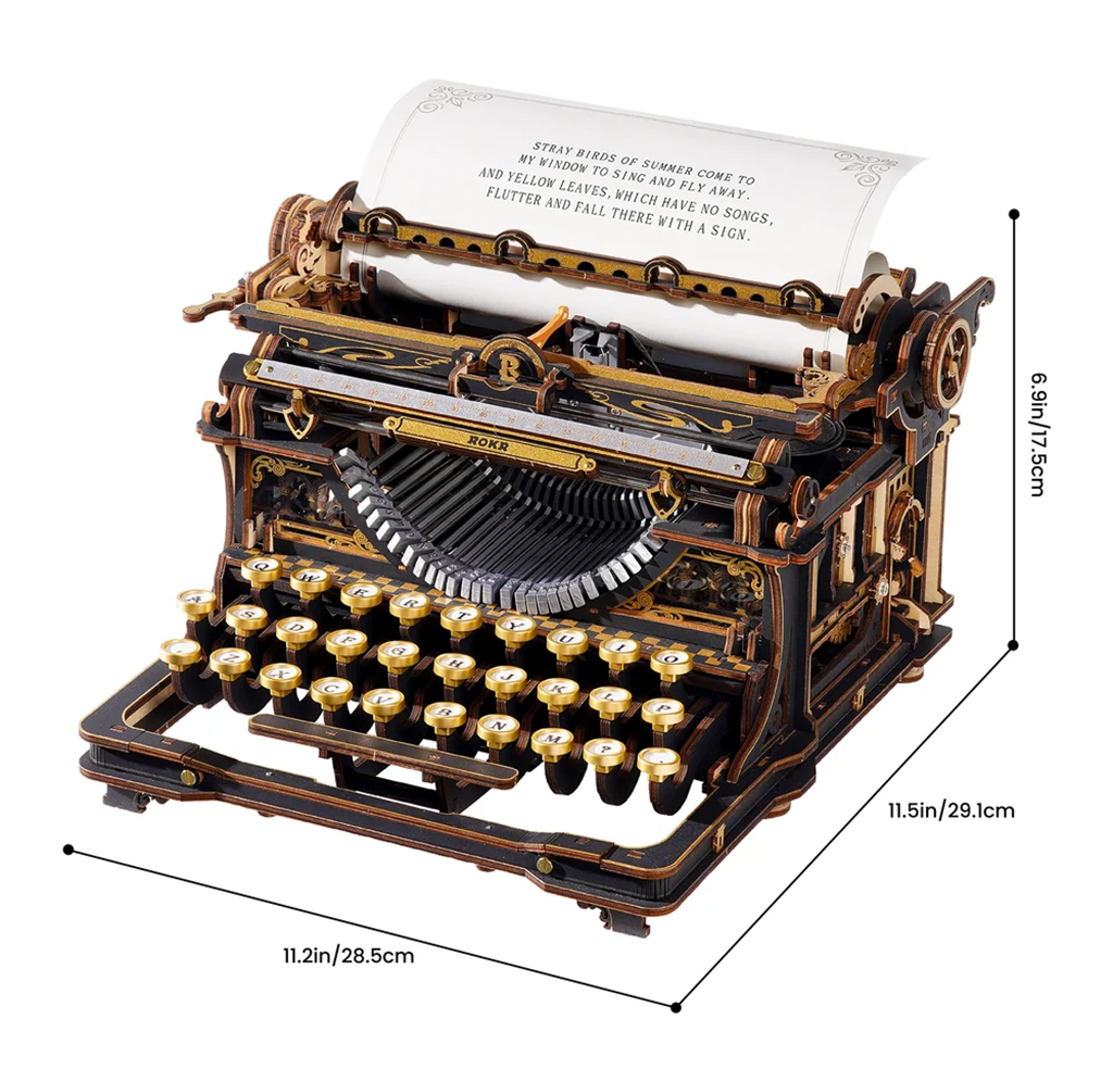 Ornate black-and-gold antique-style typewriter with round keys and a sheet of typed text, shown with dimensions; its craftsmanship feels elegant and nostalgic.