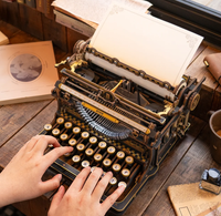 Hands typing on an ornate vintage typewriter with a blank, decorative page, surrounded by papers and ink on a wooden desk; warm, nostalgic mood.