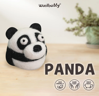 A handmade black-and-white wool panda sits on a pale wooden table beneath the “woolbuddy” logo and bold “PANDA” text; eco-friendly, 100% wool, crafted with a playful tone.