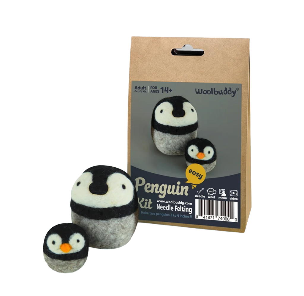 Product photo of a Woolbuddy penguin needle-felting kit: a box displays two felt penguins, with larger and smaller figures in front, creating a playful craft feel.