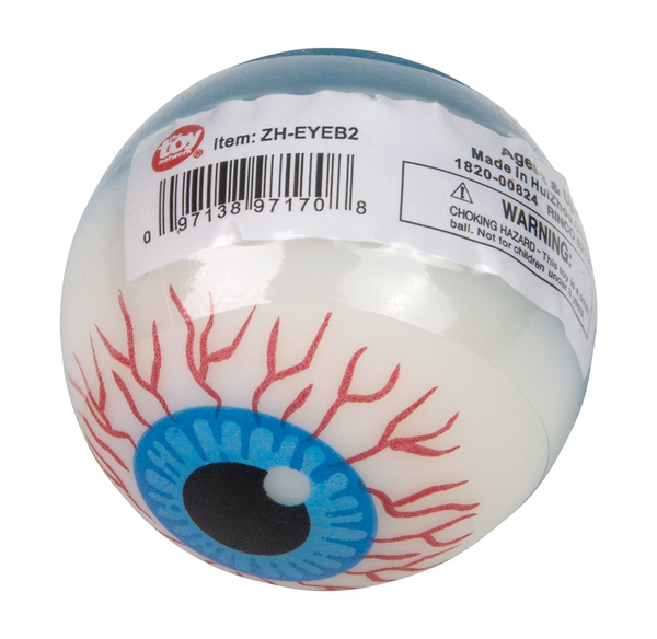 White novelty eyeball bouncy ball with a blue iris, black pupil, and red veins, shown in labeled packaging; playful yet slightly eerie.