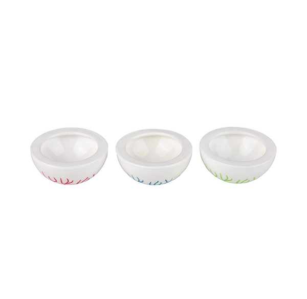 Three small white eyeball popper toy with colorful vein patterns at the base, arranged in a row on a plain white background.