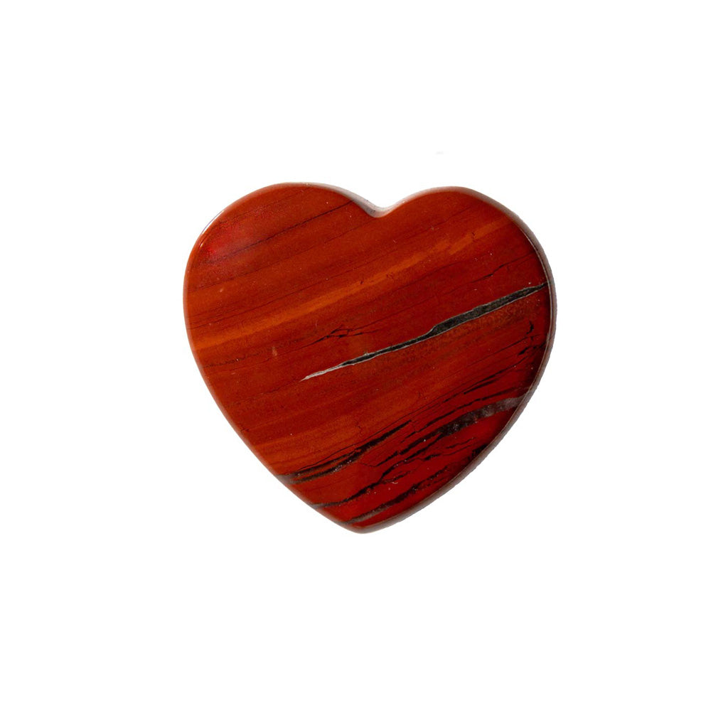 A red stone caved into the shape of a heart on a white background