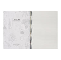 Open spiral-bound notebook with decorative cover and lined pages on a white background