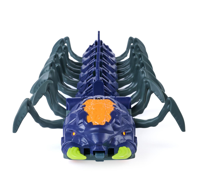 Front view of a dark blue scorpion-like toy with many curved legs, bright green pincers, and an orange textured panel, conveying a playful tone.