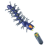 Blue segmented robotic centipede toy with many legs, orange and green details, positioned beside its handheld remote on a white background.