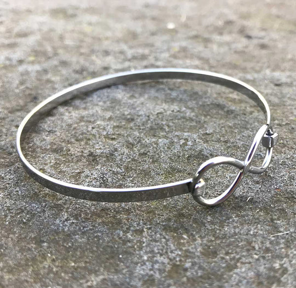 3/4 view of silver infinity bracelet.