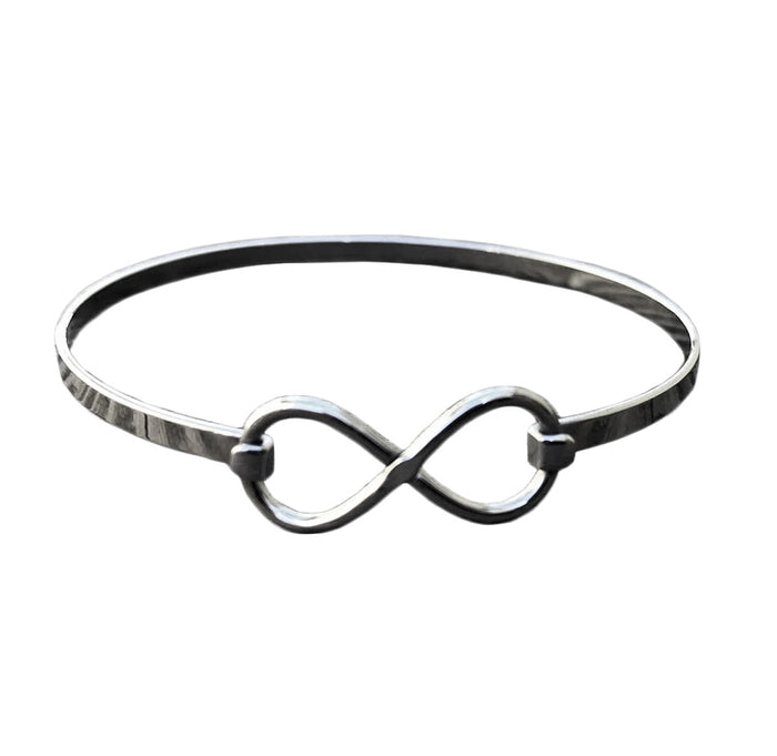 A silver bracelet with an infinity symbol on it.
