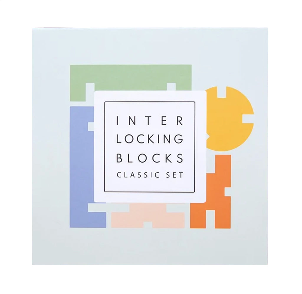 The product packaging for the 'Interlocking Blocks Classic Set' shows a white square box with a minimalist graphic of colorful interlocking puzzle-like blocks in green, blue, yellow, orange, and pink on a very light gray background.