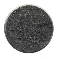 A round black iron coin with a highly detailed, textured lunar surface design featuring craters and shadows, isolated on a white background.