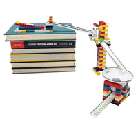 An example of a chain reaction with the start on top of books moving round white ramps and a white funnel with yellow, red, blue and green bricks.