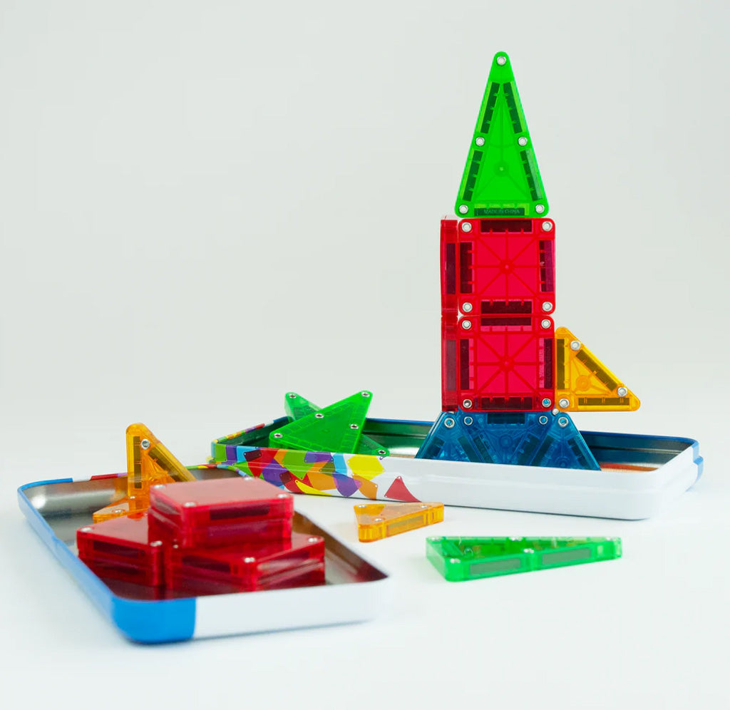 Colorful magnetic building blocks on a white tray with a white background