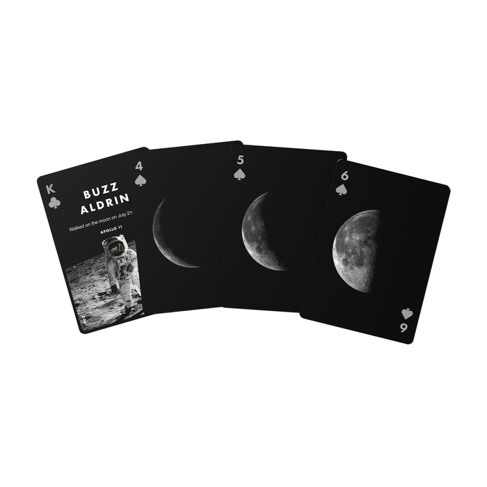 Four black playing cards fanned out on a white background, featuring moon phase imagery and the text 'BUZZ ALDRIN' on the top card.