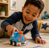 A joyful young boy plays with a blue toy train on the living-room rug, smiling as he pushes it; warm, cozy home setting with playful energy.