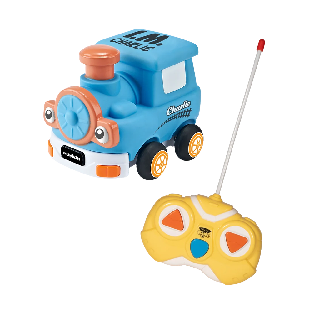 A cheerful blue cartoon locomotive toy with orange accents and big eyes sits beside a yellow remote control with a long antenna, on a white background.