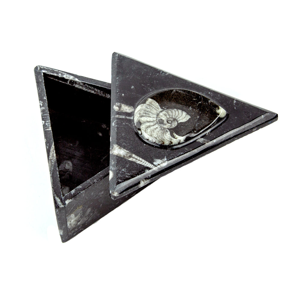 Triangular black stone box that is slightly open. 
