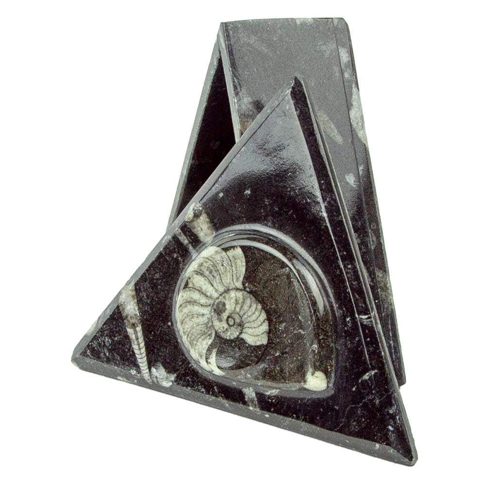 Triangular box standing on one side with the lid propped against the side. 