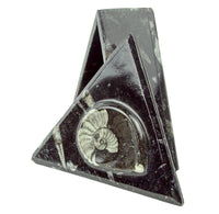 Triangular box standing on one side with the lid propped against the side. 