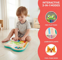 A young child plays a colorful light-up piano on the floor; a red panel shows free play, learning lights, and pixel piano modes.
