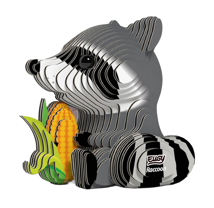 Racoon 3D model made out of cardboard each pieces set together with a piece of corn in its arms.