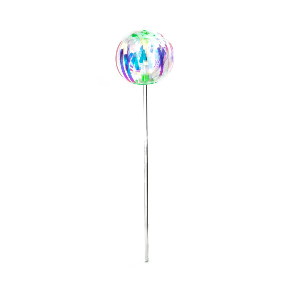 Iridescent strips of plastic in the shape of a sphere on a stick against a white background