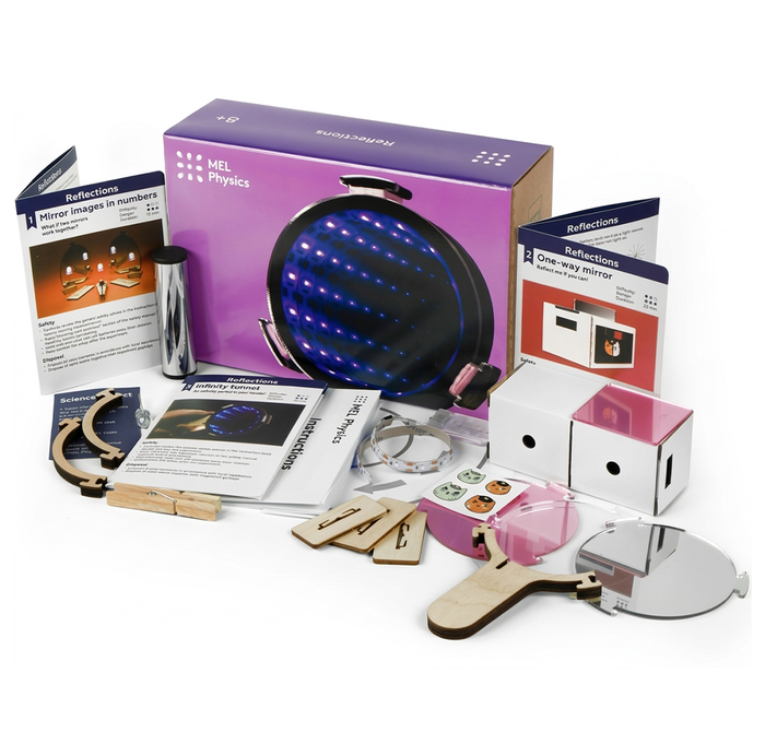 A MEL Physics optics kit with a large mirror, lenses, colored filters, handheld tools, and instruction booklets, arranged to showcase playful science experiments.